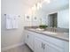 Clean bathroom with double sink vanity, gray countertops, white cabinets, and stylish fixtures at 4835 Lullaby Ln, Kissimmee, FL 34746