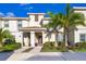 Charming two-story townhouse with a well-manicured lawn and mature palm trees at 4835 Lullaby Ln, Kissimmee, FL 34746