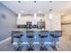 Eat-in kitchen island with pendant lights, bar stools, and stainless steel appliances at 4835 Lullaby Ln, Kissimmee, FL 34746