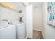 Efficient laundry area includes washer, dryer, wire shelving, and extra storage space at 4835 Lullaby Ln, Kissimmee, FL 34746