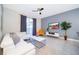 Comfortable living room with modern decor, a ceiling fan, and view to the pool at 4835 Lullaby Ln, Kissimmee, FL 34746