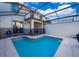 Inviting backyard pool is surrounded by screened enclosure, and covered lanai with seating area at 4835 Lullaby Ln, Kissimmee, FL 34746