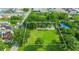 Expansive aerial view showcasing a lush green lot with mature trees and a defined boundary line at 512 Palmetto St, Orlando, FL 32824
