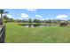 Expansive backyard with serene pond views and lush green grass, perfect for relaxation and outdoor activities at 545 Fairhaven Dr, Davenport, FL 33837