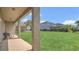 Spacious backyard featuring a well-maintained lawn and a covered patio at 545 Fairhaven Dr, Davenport, FL 33837