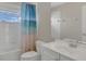 Bathroom showcasing a shower-tub combo with curtain and a white vanity with sink at 545 Fairhaven Dr, Davenport, FL 33837