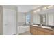 Bright bathroom featuring double vanity, bathtub, and separate glass-enclosed shower at 545 Fairhaven Dr, Davenport, FL 33837