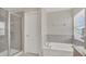 Luxurious bathroom showcasing a glass-enclosed shower and a separate soaking tub at 545 Fairhaven Dr, Davenport, FL 33837