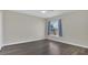 Bedroom featuring wood flooring, neutral walls, and a window with curtains at 545 Fairhaven Dr, Davenport, FL 33837
