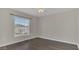 Empty bedroom features wood flooring, neutral walls, and natural light from a window at 545 Fairhaven Dr, Davenport, FL 33837