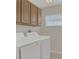 Laundry room featuring a washer and dryer and overhead cabinets for storage at 545 Fairhaven Dr, Davenport, FL 33837