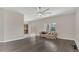 Bright living room with hardwood floors, a large ceiling fan, and a view through sliding glass doors at 545 Fairhaven Dr, Davenport, FL 33837