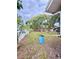 Large backyard features a blue barrel, grassy area, and a wooden fence at 6337 Lido Ct, Orlando, FL 32807