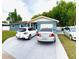 Charming single-story home with a well-maintained lawn and driveway featuring multiple vehicles at 6337 Lido Ct, Orlando, FL 32807