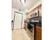 Kitchen features stainless steel oven, over-the-range microwave and stylish backsplash at 6337 Lido Ct, Orlando, FL 32807