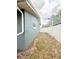 Side yard has a white fence and some grass at 6337 Lido Ct, Orlando, FL 32807