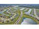 Aerial view of a neighborhood with multiple homes and ponds at 64 Citrine Loop, Kissimmee, FL 34758