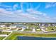 This is an aerial view of a neighborhood featuring a beautiful lake at 64 Citrine Loop, Kissimmee, FL 34758