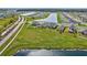 Beautiful aerial view of suburban homes surrounding a picturesque lake and lush green landscapes in a Primary planned community at 64 Citrine Loop, Kissimmee, FL 34758
