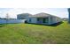 Well-maintained backyard featuring a lush lawn and privacy fence at 64 Citrine Loop, Kissimmee, FL 34758