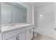 Bathroom featuring a shower over tub with white tiling and a vanity at 64 Citrine Loop, Kissimmee, FL 34758