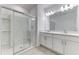 Bathroom features a glass-enclosed shower and double vanity with modern lighting at 64 Citrine Loop, Kissimmee, FL 34758