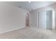 Bright bedroom features neutral walls, carpet, and closet space at 64 Citrine Loop, Kissimmee, FL 34758