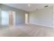 Spacious bedroom showcasing neutral walls and carpet, as well as multiple doors and ample natural light at 64 Citrine Loop, Kissimmee, FL 34758