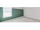 Bedroom featuring bright window and green accent wall at 64 Citrine Loop, Kissimmee, FL 34758