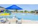 Relax by the large community pool and splash park featuring plenty of lounge chairs and tables with umbrellas at 64 Citrine Loop, Kissimmee, FL 34758