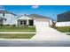 Charming single-story home with a manicured lawn and two-car garage is move-in ready at 64 Citrine Loop, Kissimmee, FL 34758