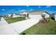 Beautiful single-story home featuring a two-car garage, fresh landscaping, and pristine curb appeal at 64 Citrine Loop, Kissimmee, FL 34758