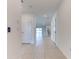 Bright foyer featuring neutral tile flooring and entry to the open-concept living area at 64 Citrine Loop, Kissimmee, FL 34758