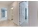 Hallway showcasing doorways to rooms with carpet and tile flooring at 64 Citrine Loop, Kissimmee, FL 34758