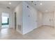 Hallway featuring neutral tile flooring with bedroom and closet doors, leading to the home's entrance at 64 Citrine Loop, Kissimmee, FL 34758