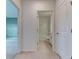 Hallway featuring neutral tile flooring with bedroom and bathroom doors at 64 Citrine Loop, Kissimmee, FL 34758