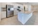 Modern kitchen with stainless steel appliances, a large island, and ample cabinet space at 64 Citrine Loop, Kissimmee, FL 34758