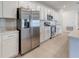 Modern kitchen with stainless steel appliances, white cabinets, and quartz countertops at 64 Citrine Loop, Kissimmee, FL 34758