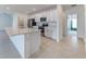 Kitchen featuring an island, stainless steel appliances, and white cabinets at 64 Citrine Loop, Kissimmee, FL 34758