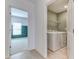 Laundry room with a window view of the bedroom and modern washer and dryer at 64 Citrine Loop, Kissimmee, FL 34758