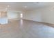 Open living area featuring neutral tile floors, recessed lighting, and views into the kitchen at 64 Citrine Loop, Kissimmee, FL 34758