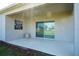 Covered patio offers a relaxing outdoor space with sliding glass door at 64 Citrine Loop, Kissimmee, FL 34758