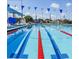 The crystal clear swimming pool features vibrant red lane markers and blue accents with festive blue and white pennant flags at 64 Citrine Loop, Kissimmee, FL 34758