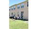 Townhouse with a patio, sliding glass door, and a well-maintained grassy backyard at 645 Captiva Cir, Kissimmee, FL 34741