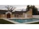Community pool surrounded by a paved deck and lush landscaping at 645 Captiva Cir, Kissimmee, FL 34741