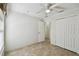 Neutral bedroom features tile flooring, a ceiling fan and a closet at 782 Vineyard Way, Poinciana, FL 34759