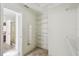 Walk-in closet with installed shelving, with an adjoining bathroom and bedroom at 782 Vineyard Way, Poinciana, FL 34759