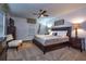 Comfortable bedroom with a ceiling fan, a plush bed, and modern decor at 8945 Cuban Palm Rd, Kissimmee, FL 34747