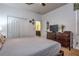 Bright bedroom with a neutral color scheme, carpeted floor, and large dresser with a television on top at 8945 Cuban Palm Rd, Kissimmee, FL 34747