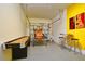 Finished garage with entertainment area, basketball game, and decorated with guitars at 8945 Cuban Palm Rd, Kissimmee, FL 34747